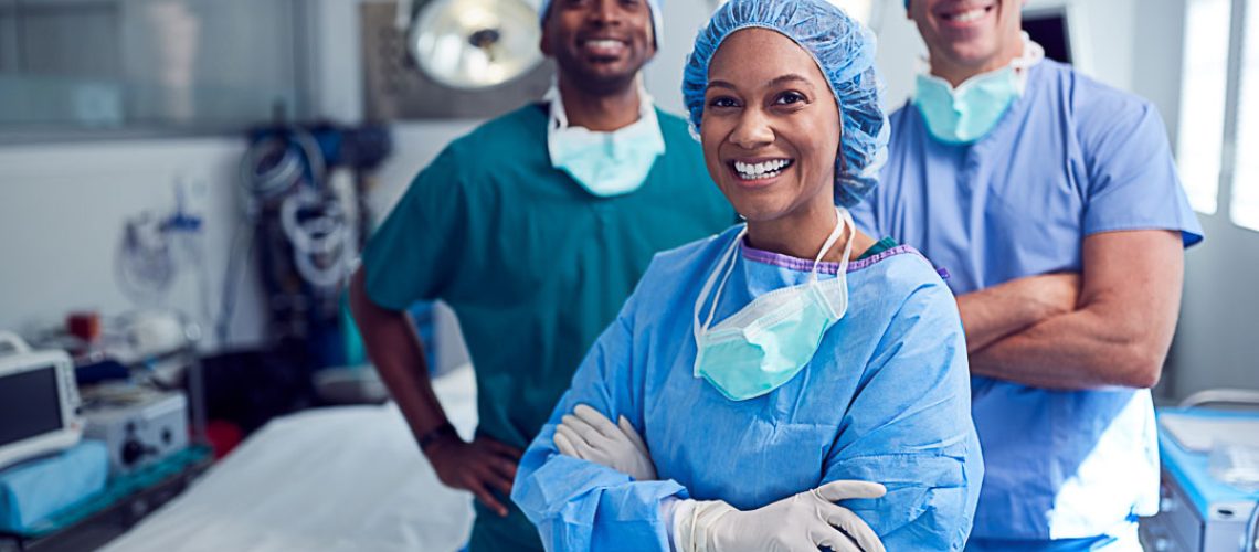Portrait Of Multi-Cultural Surgical Team Standing In Hospital Operating Theater